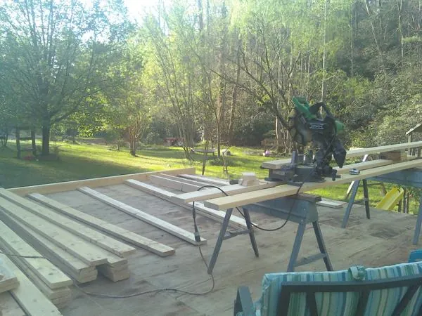 Miter saw and framing lumber on a deck under construction in Gulf Breeze
